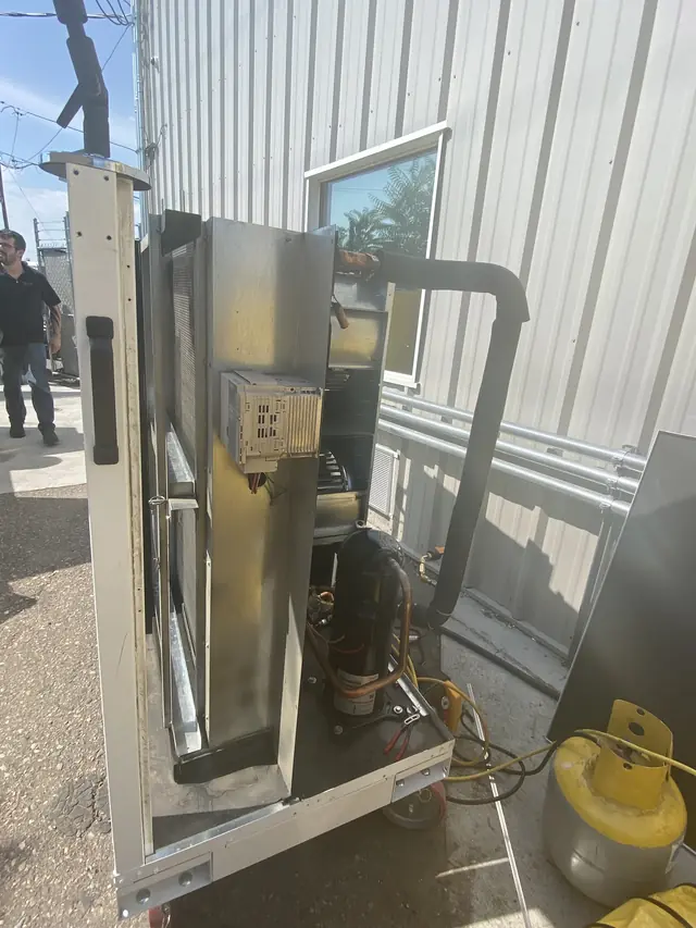 Technician repairing an outdoor AC unit